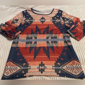 Women’s long-sleeve top featuring a navy and sunset-colored Aztec print